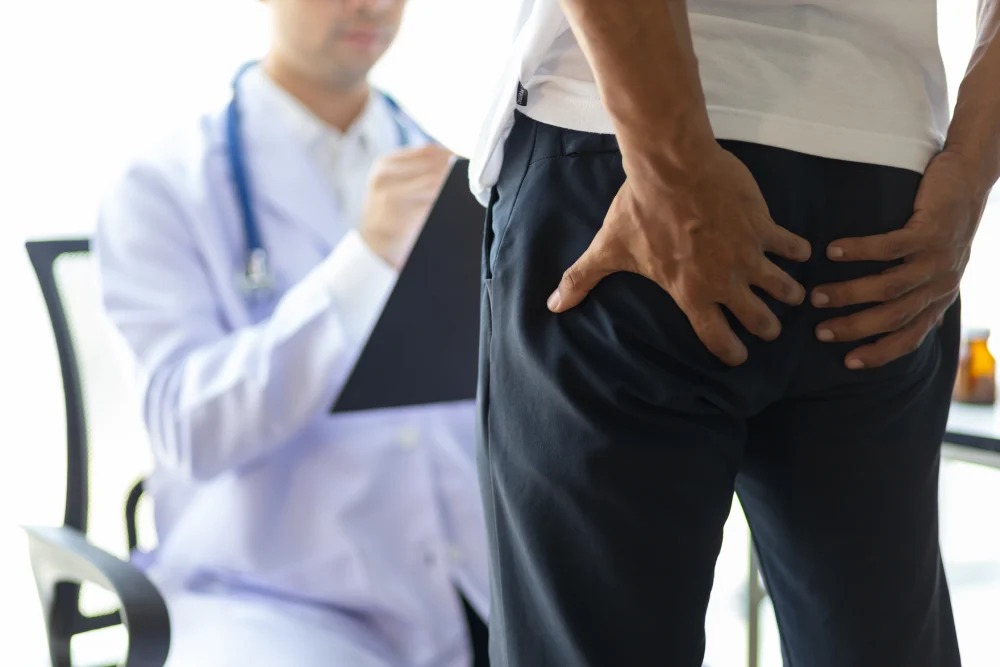 Man consulting a colorectal surgeon to discuss piles removal surgery.
